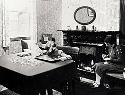 Living room with girl doing a puzzle, around 1939